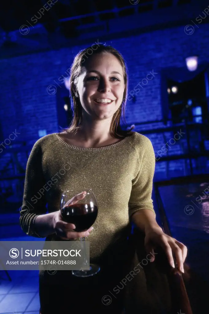Close-up of a young woman holding a glass of red wine