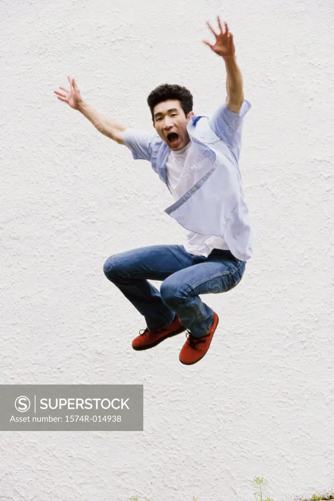 Young man jumping with his arms outstretched