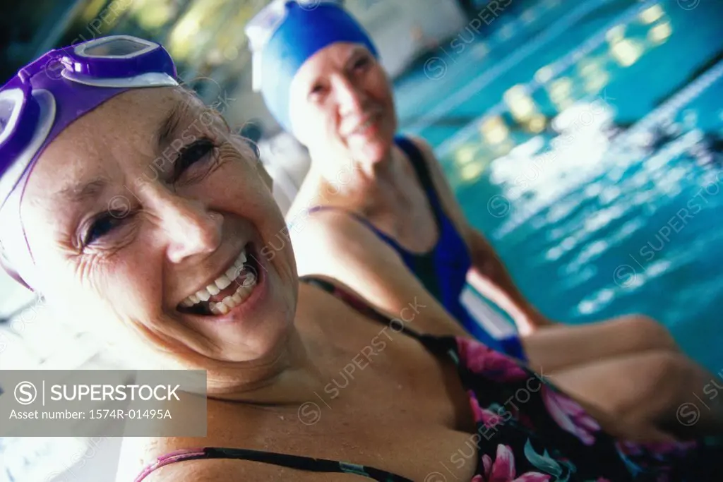 Portrait of two senior women at a swimming pool