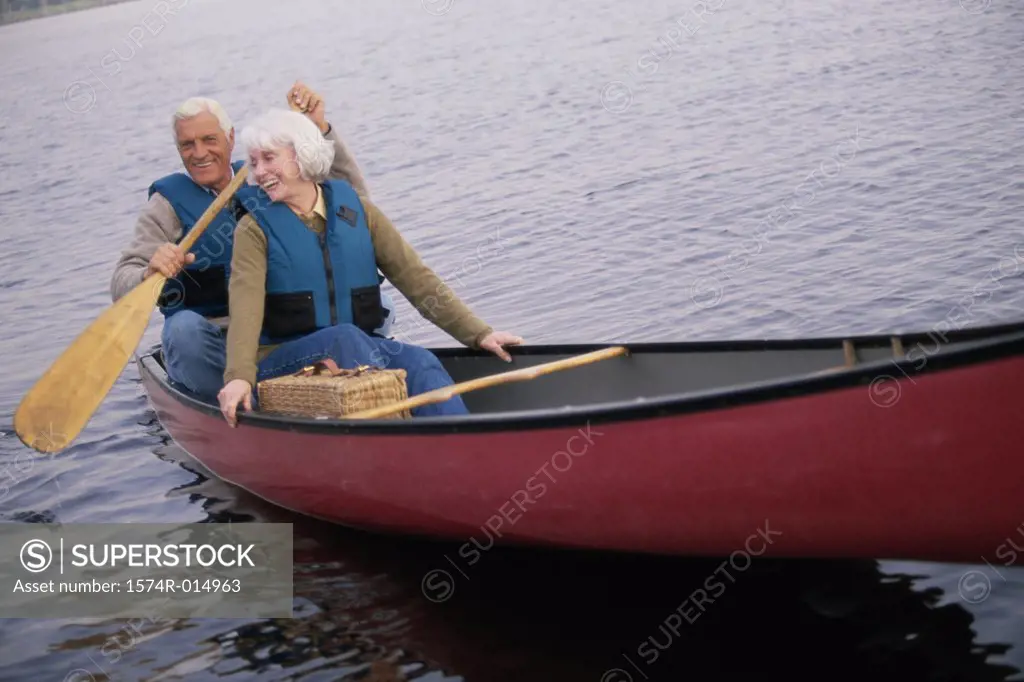 Senior couple rowing a boat
