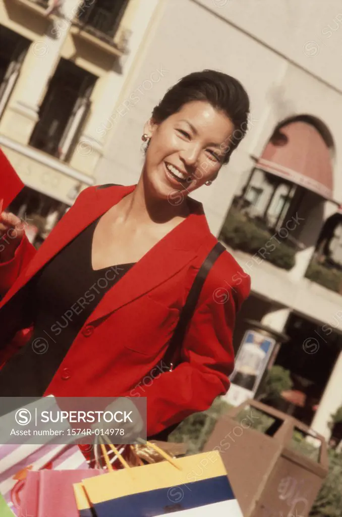 Close-up of a young woman holding a shopping bag
