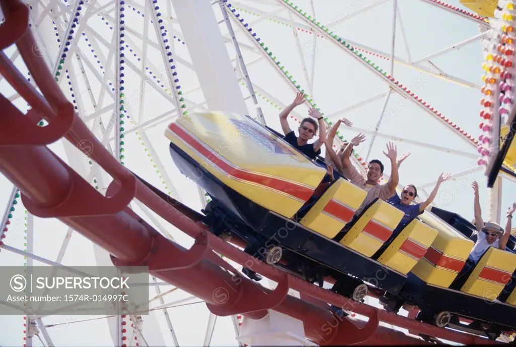Low angle view of five people on a rollercoaster