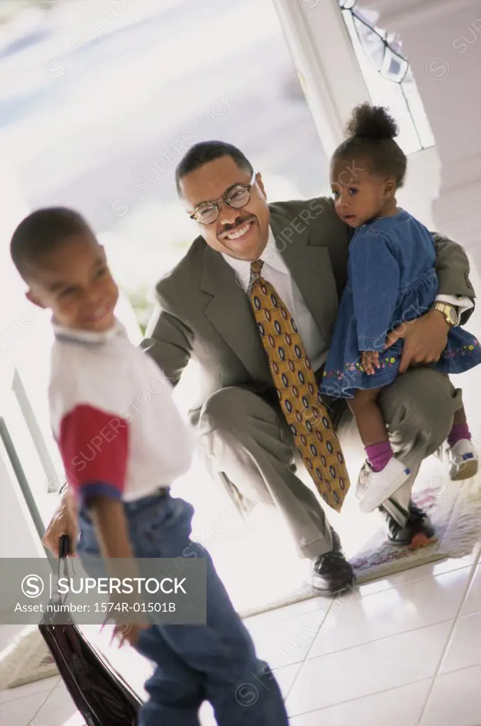 Businessman meeting his son and daughter at the door