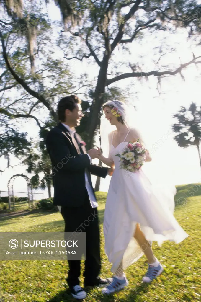 Side profile of a newlywed couple standing in a park