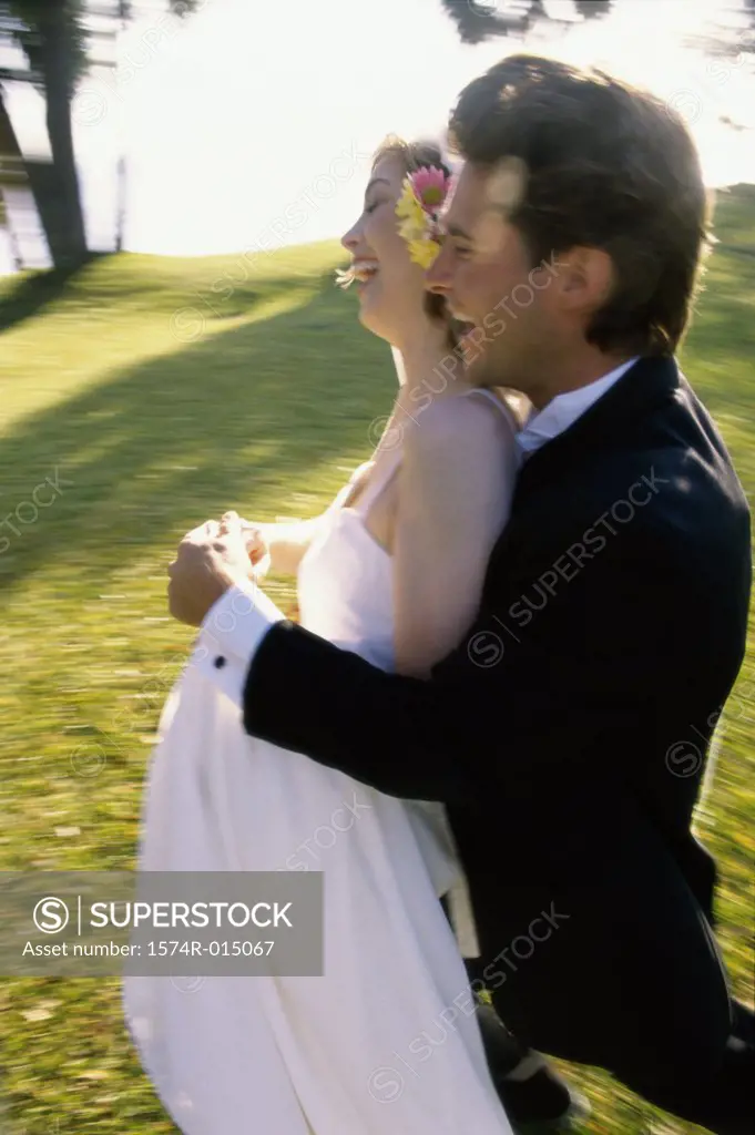 Side profile of a newlywed couple laughing