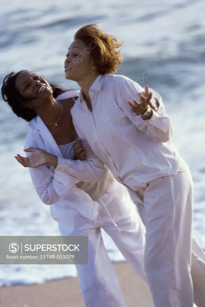Mother walking with her daughter on the beach