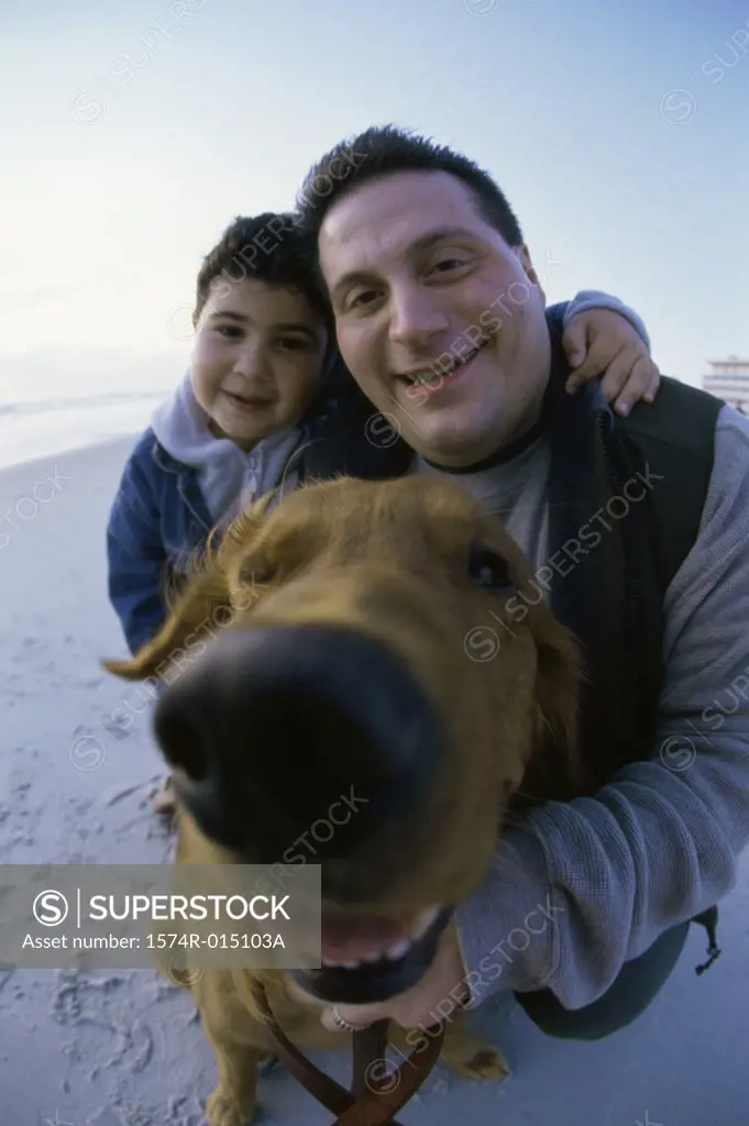 Portrait of a father and son with their dog