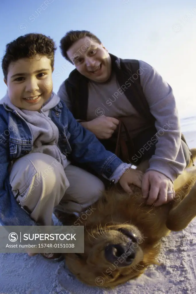 Portrait of a father and son with their dog
