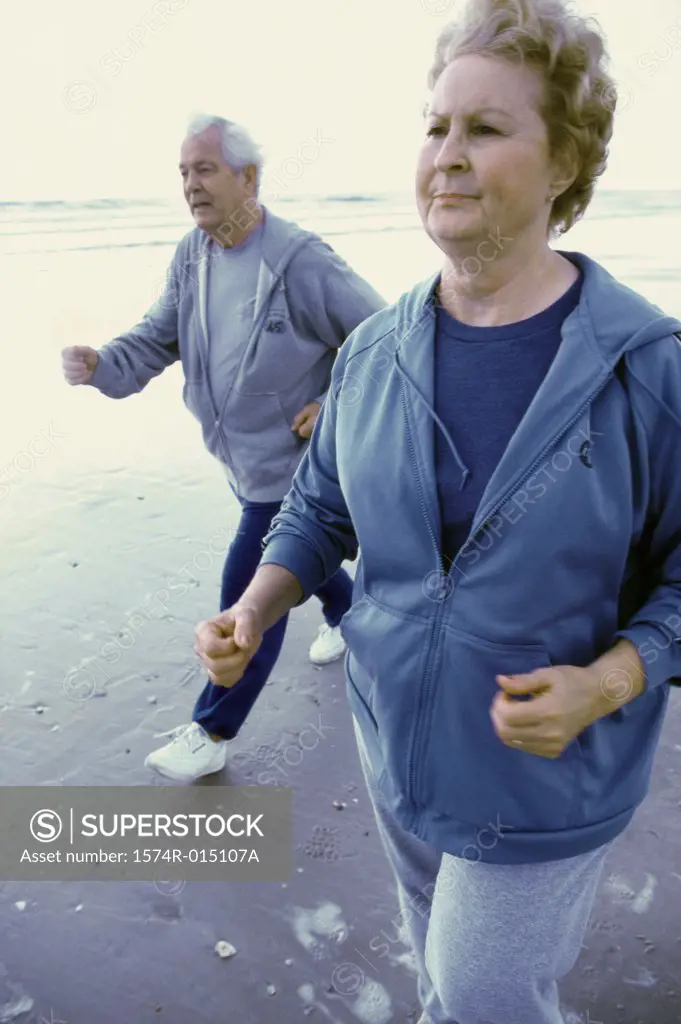 Senior couple jogging on the beach