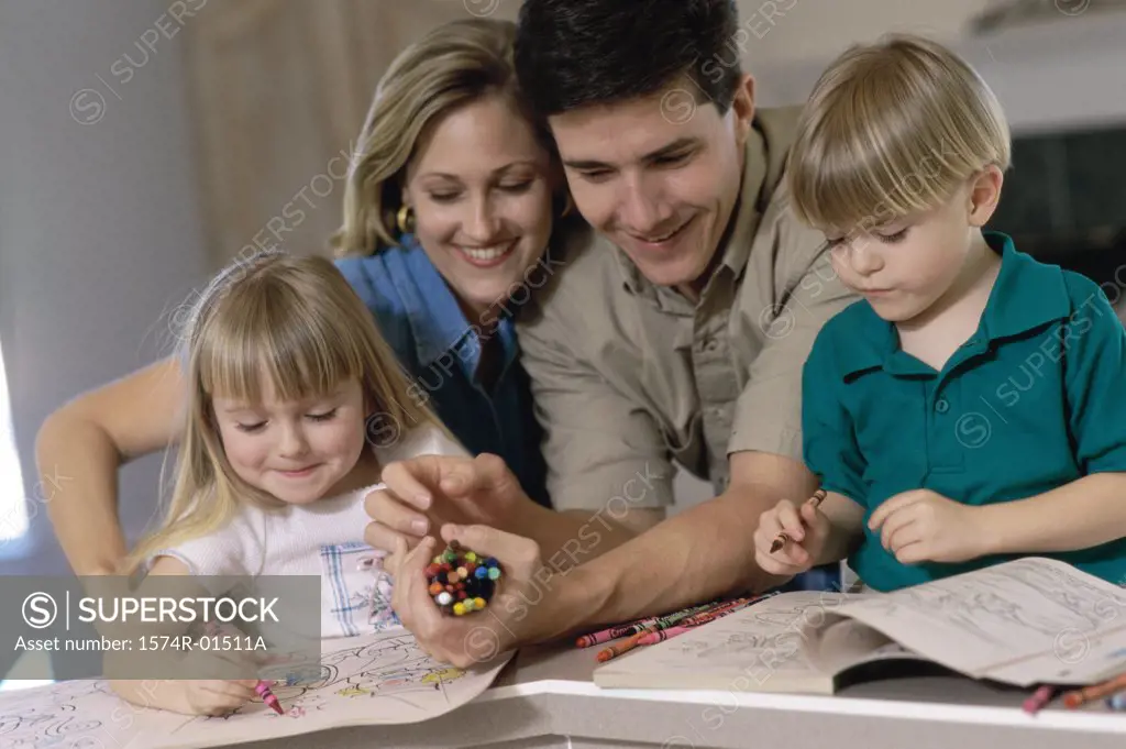 Parents and their children drawing in a coloring book