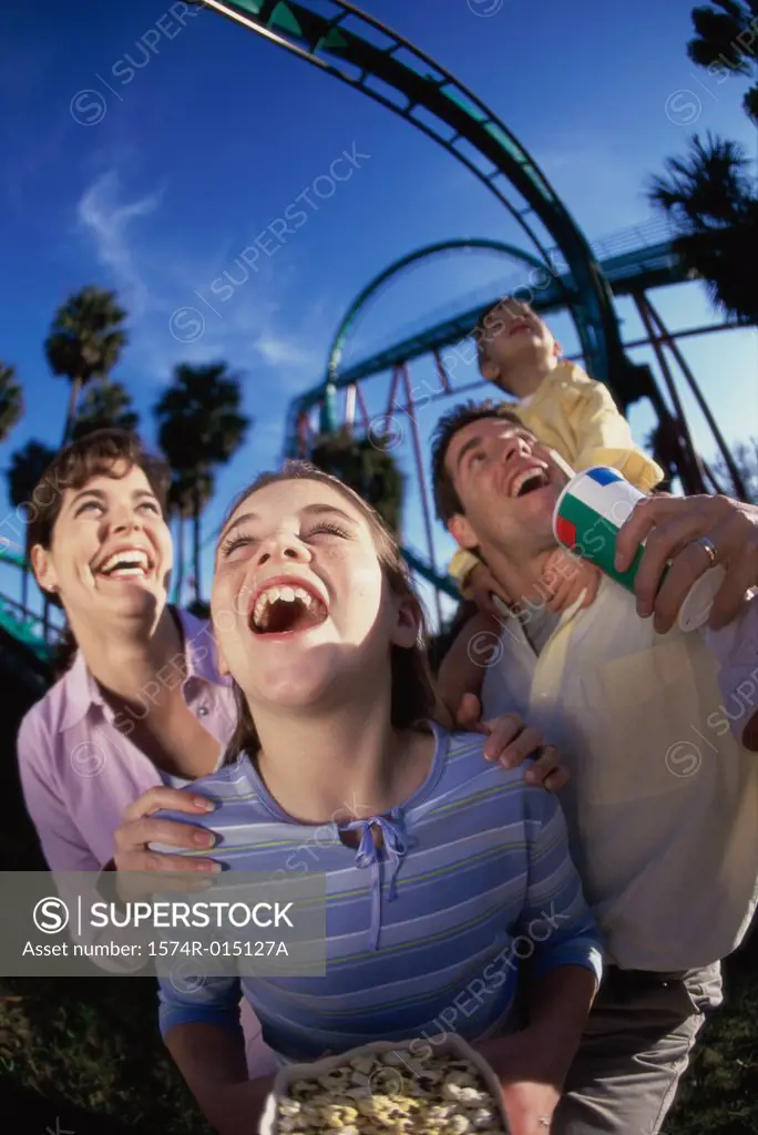 Low angle view of parents with their son and daughter in an amusement park