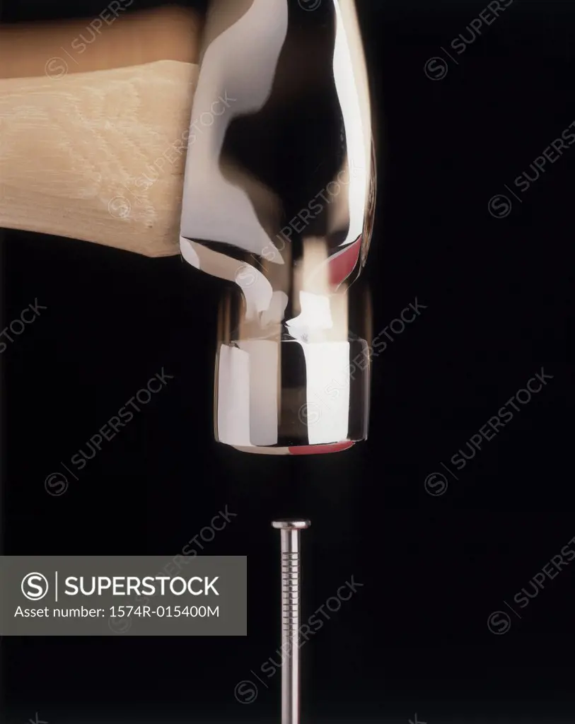 Close-up of a hammer hitting a nail