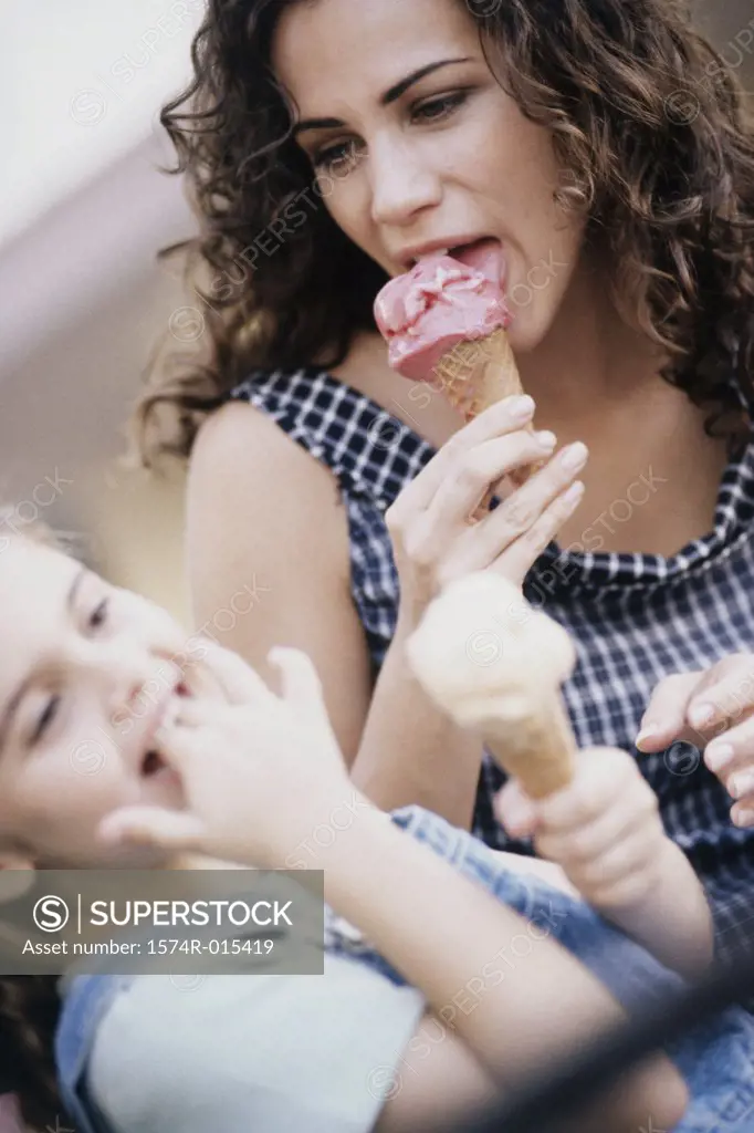 Close-up of a mother eating ice cream with her daughter