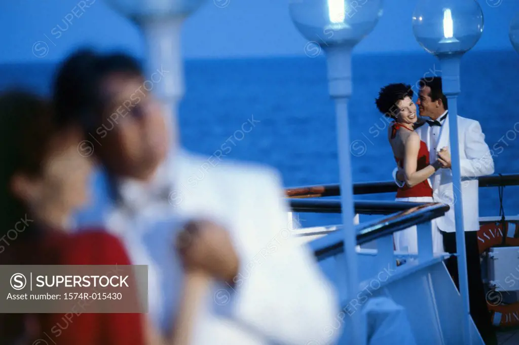 Young couple dancing on the deck of a cruise ship