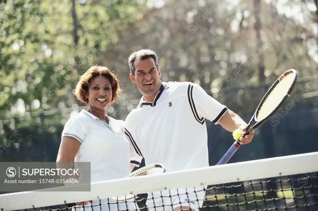 Portrait of a mid adult couple playing tennis