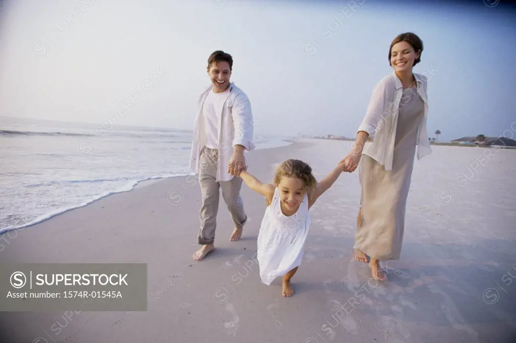 Couple with their daughter on the beach