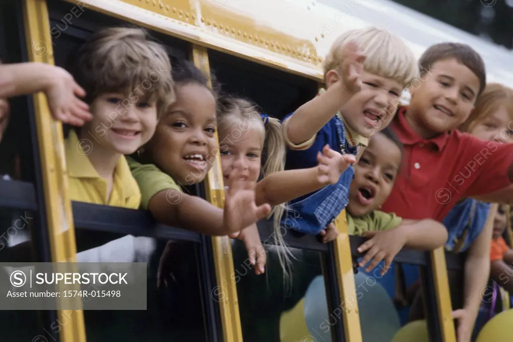 Group of students looking out of a school bus