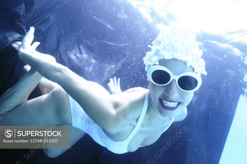 Portrait of a young woman swimming underwater