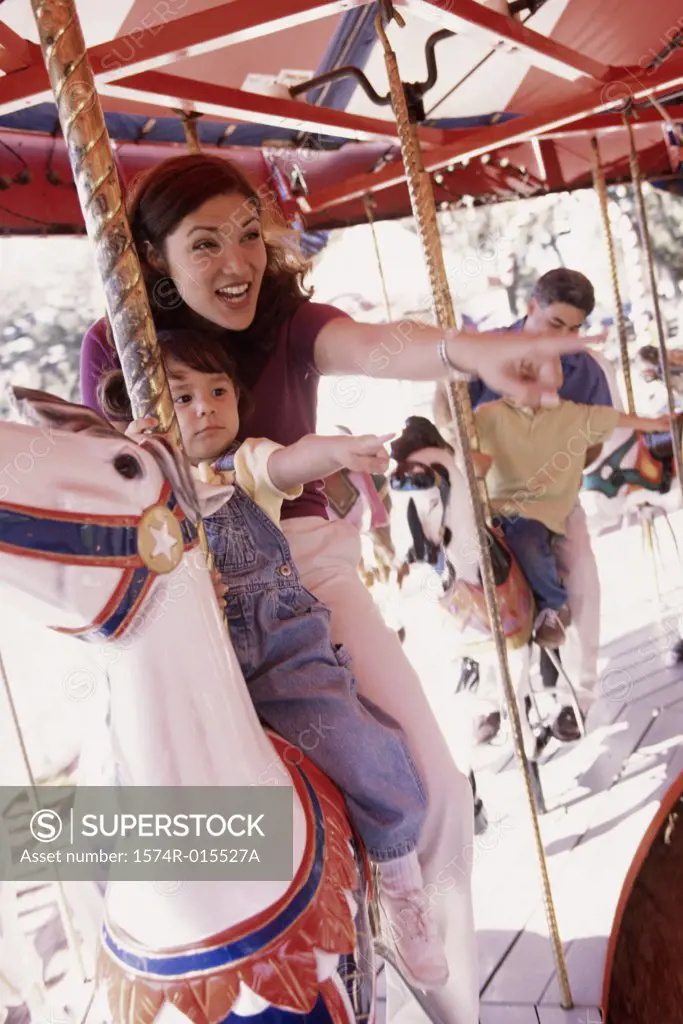 Mother and son sitting on a carousel in an amusement park