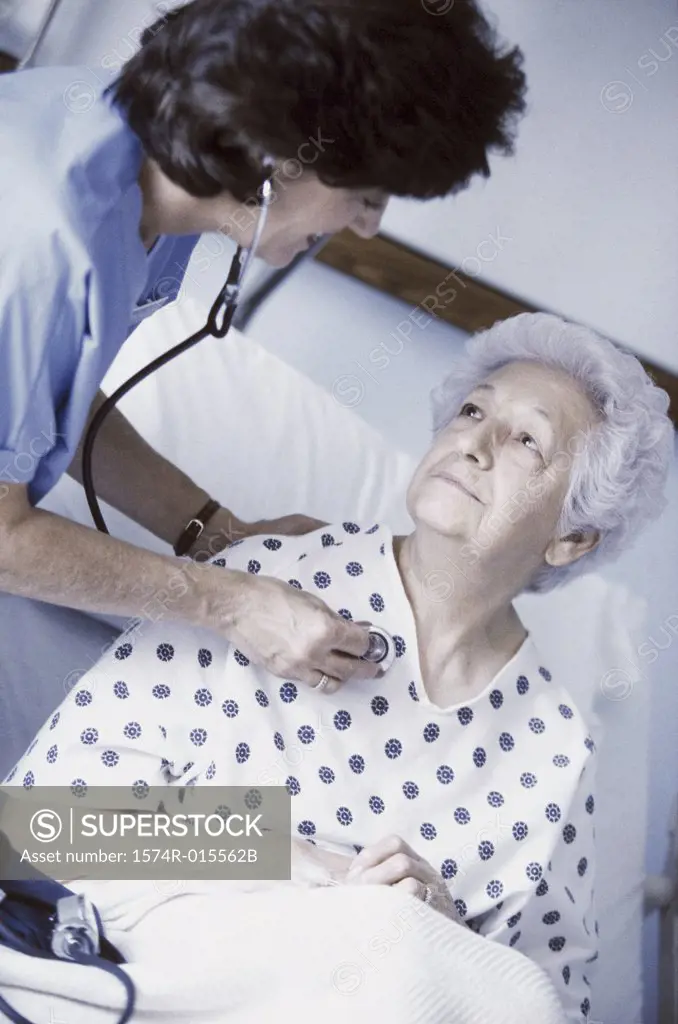 High angle view of a female nurse examining a senior woman