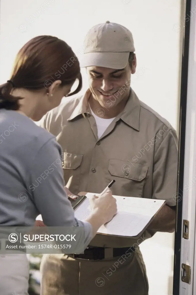 Young woman signing for a delivery