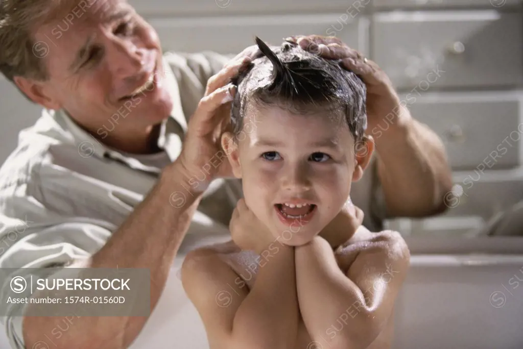 Close-up of a man shampooing his son's hair