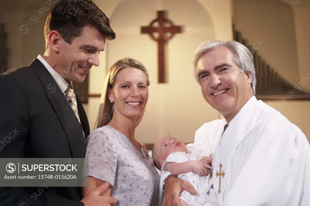 Close-up of parents with their son at a baptism