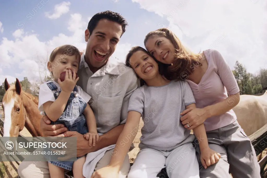 Portrait of parents sitting with their son and daughter