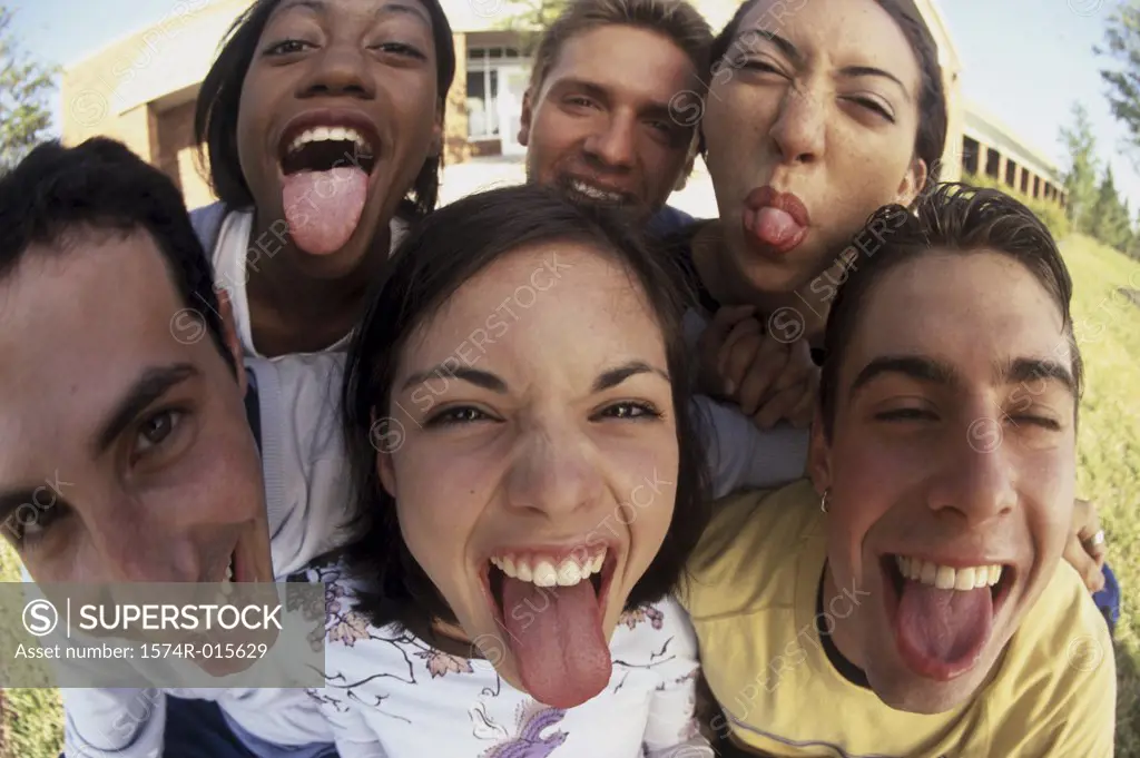 Portrait of a group of teenagers sticking out their tongues