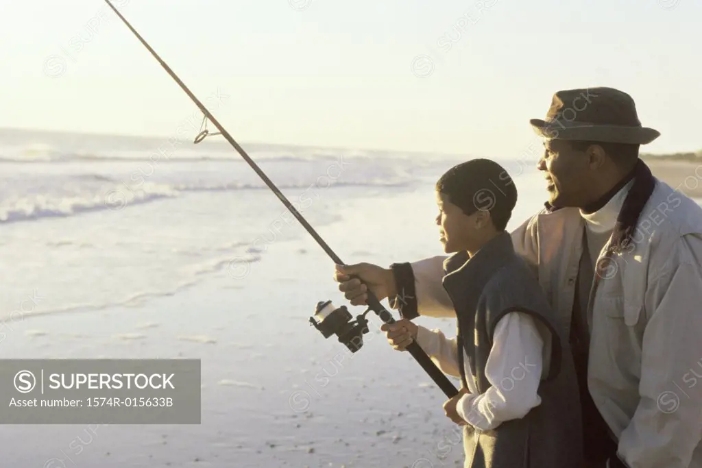 Close-up of a father teaching his son fishing