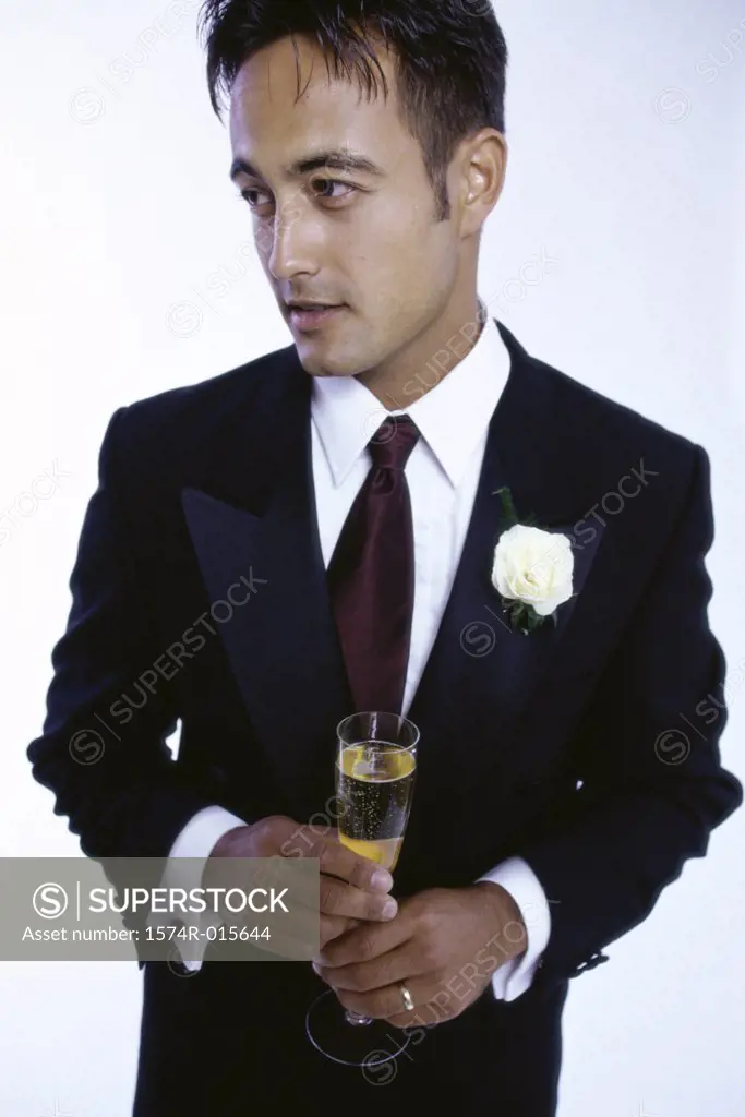 Young man holding a champagne flute