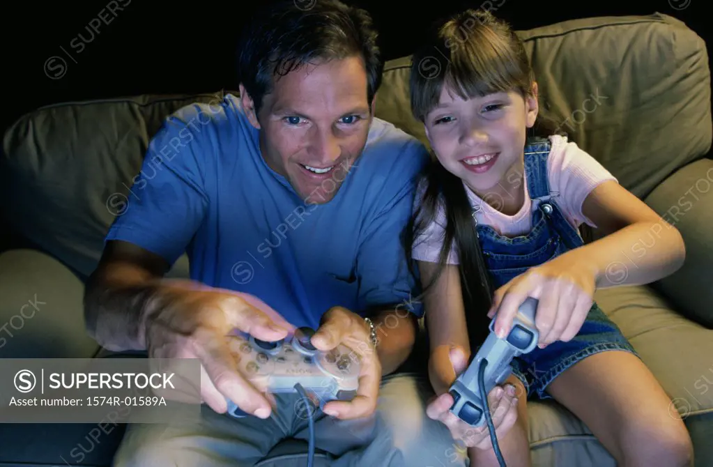 Father and daughter playing a video game together
