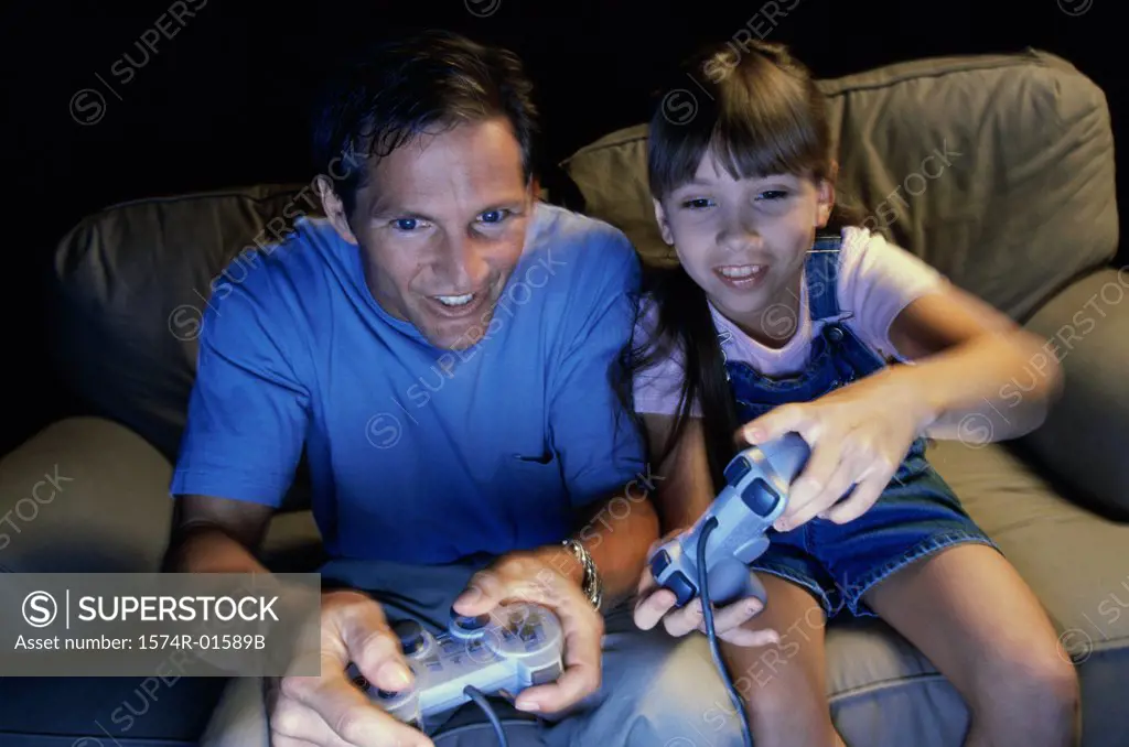 Father playing video games with his daughter
