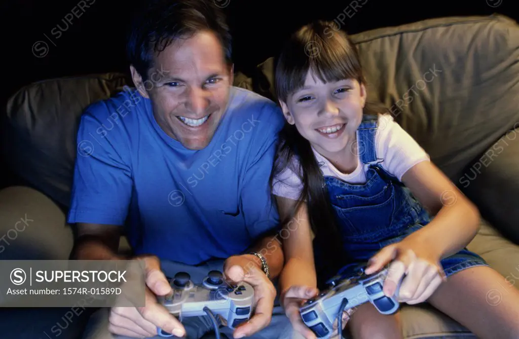 Father playing video games with his daughter