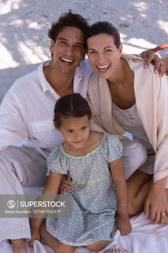 Portrait of parents sitting with their daughter