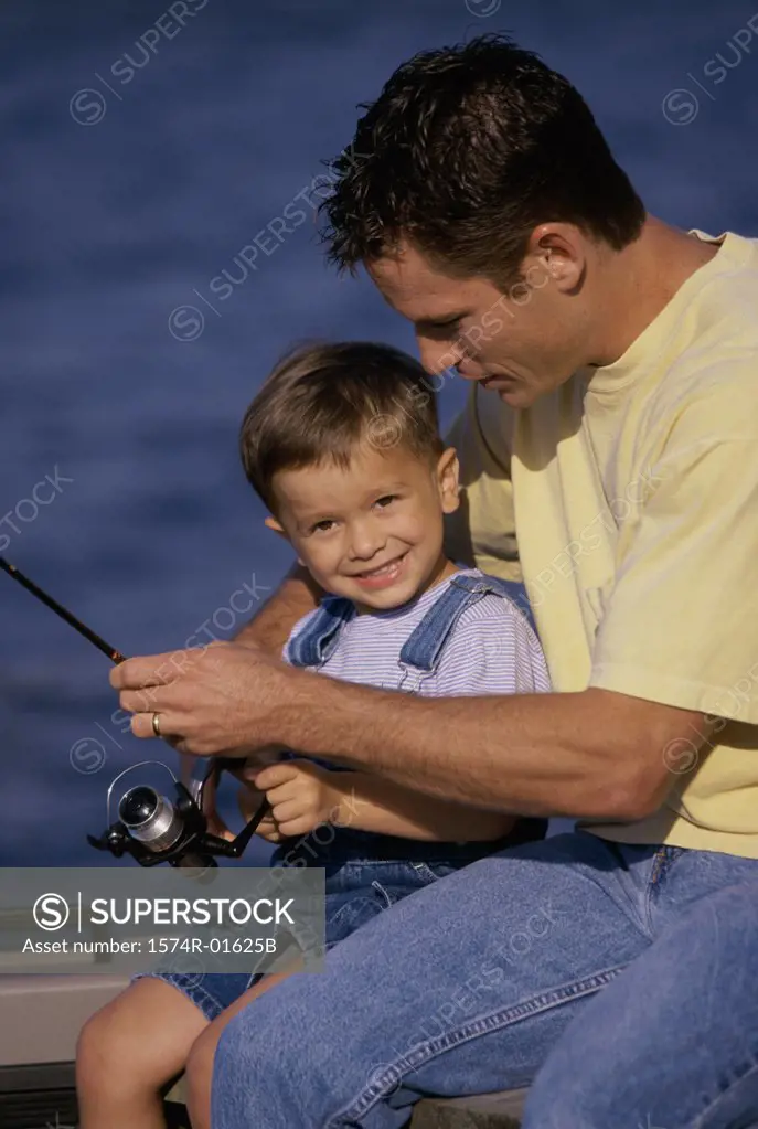 Father and son fishing from a boat