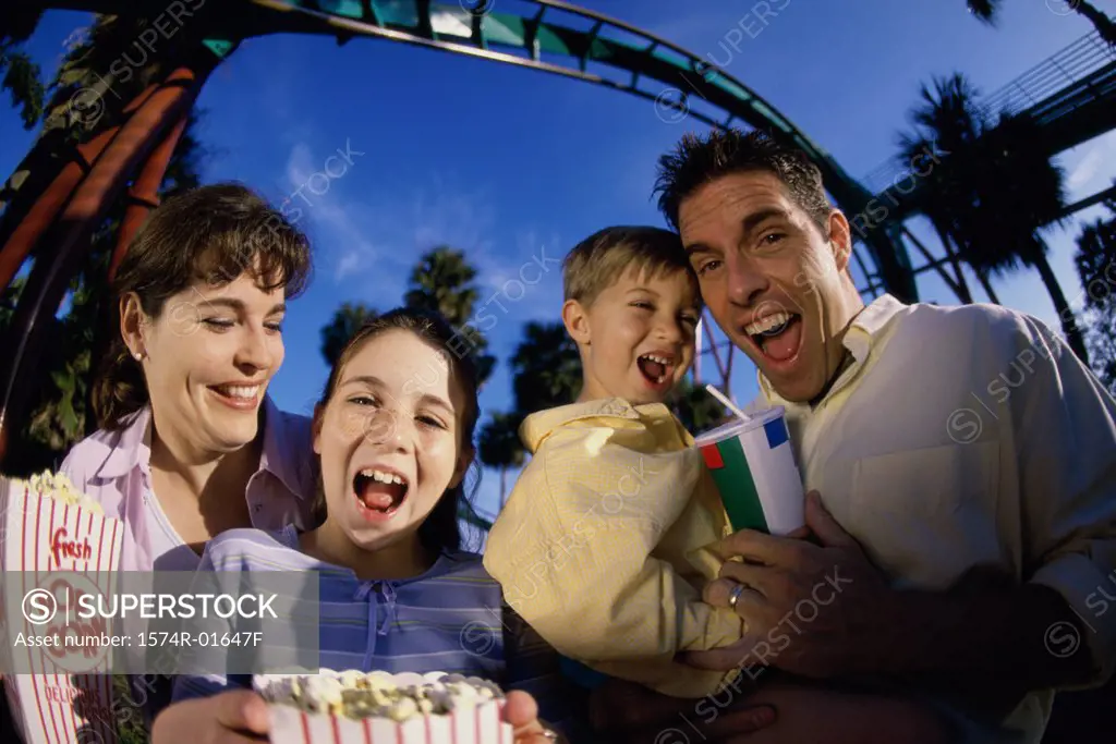 Portrait of parents with their son and daughter in an amusement park