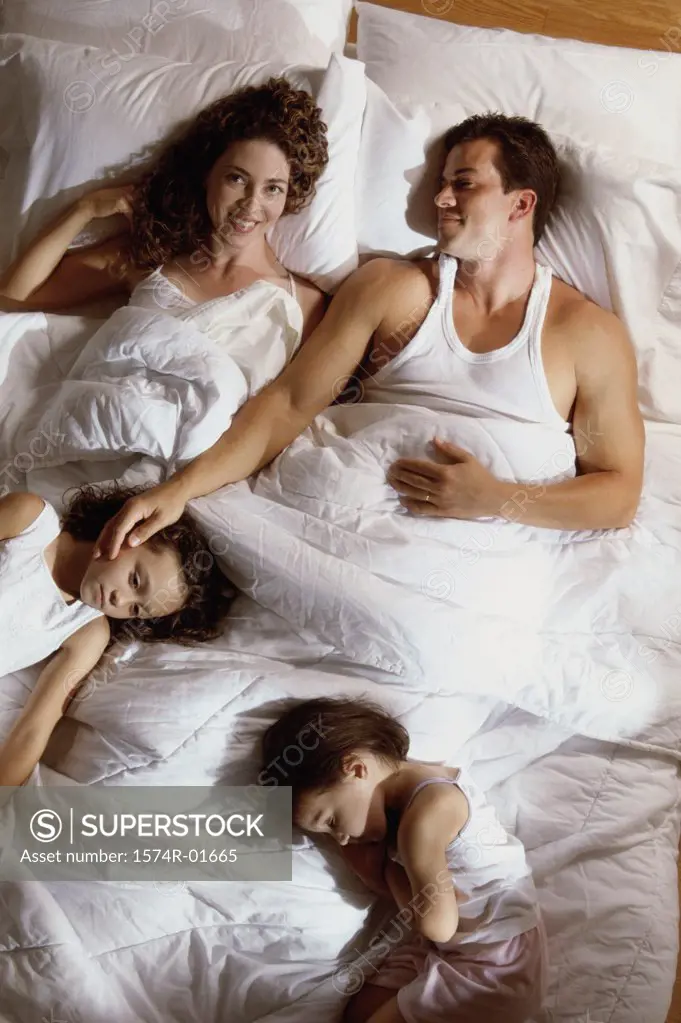 High angle view of a couple in bed with their son and daughter 