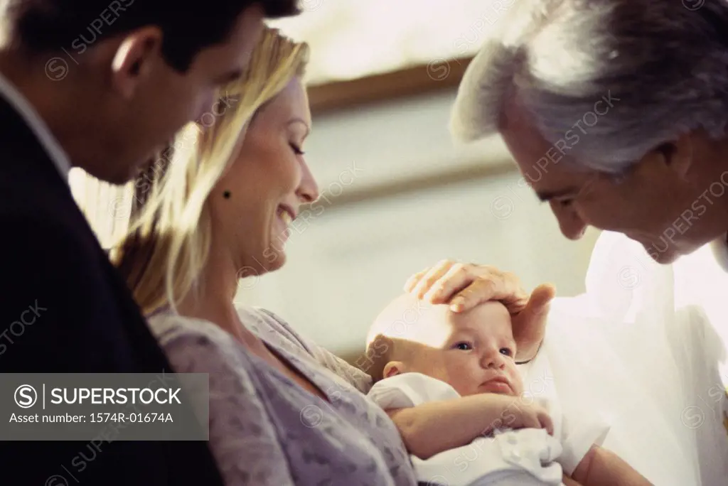 Close-up of a priest blessing a baby