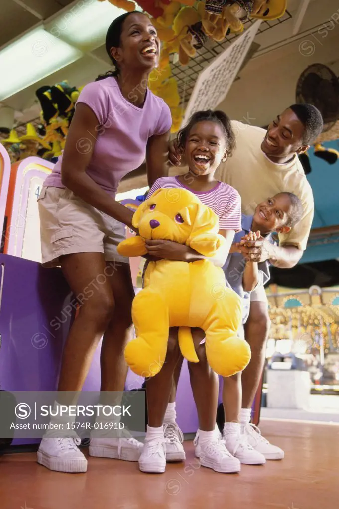 Parents with their son and daughter at an amusement park