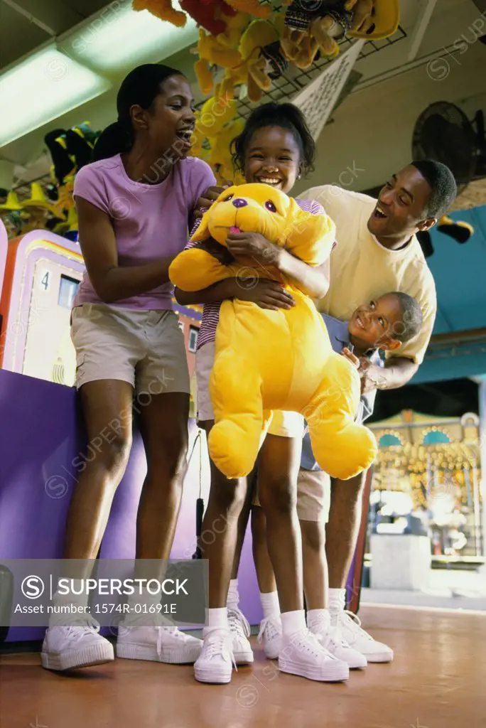 Low angle view of a couple in an amusement park with their son and daughter 