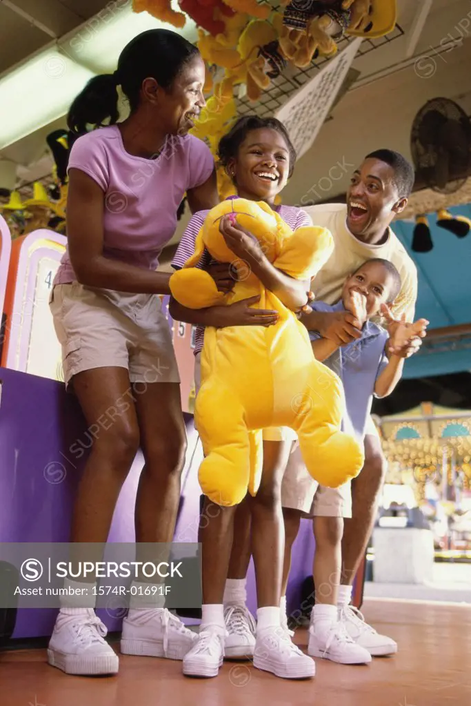 Parents with their son and daughter at an amusement park
