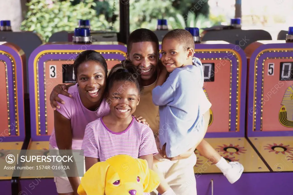 Portrait of parents with their son and daughter at an amusement park
