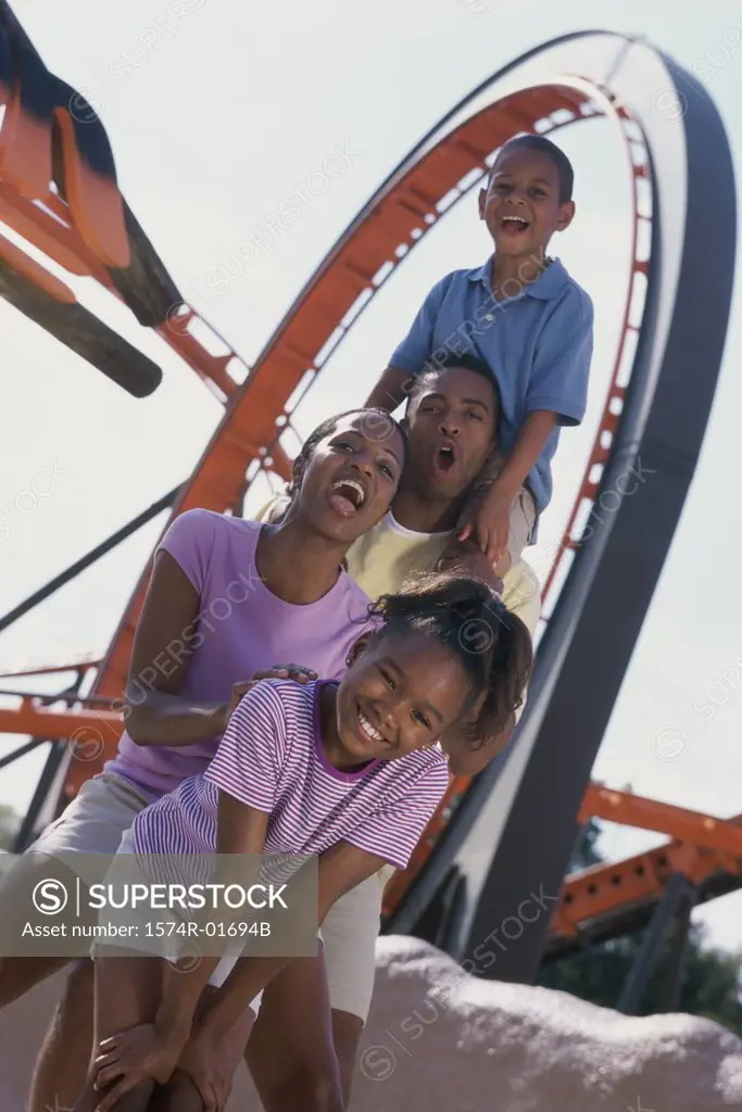 Portrait of parents with their son and daughter at an amusement park