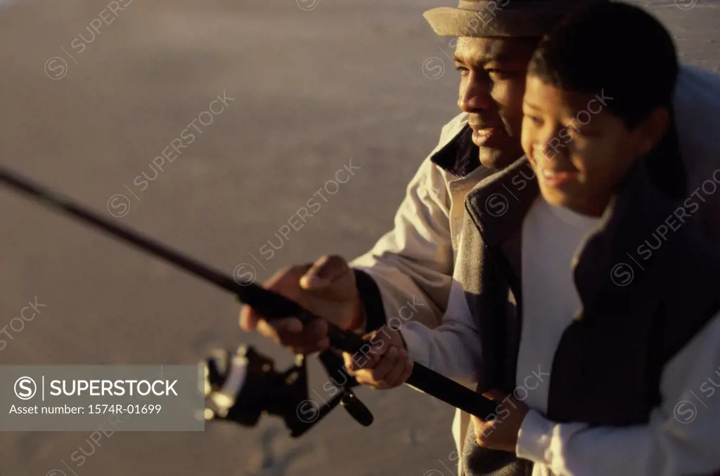 Close-up of a father and son fishing together