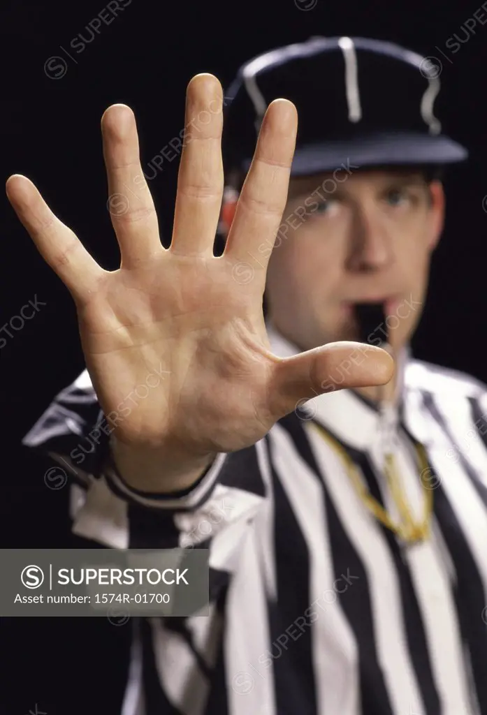 Portrait of a referee blowing a whistle