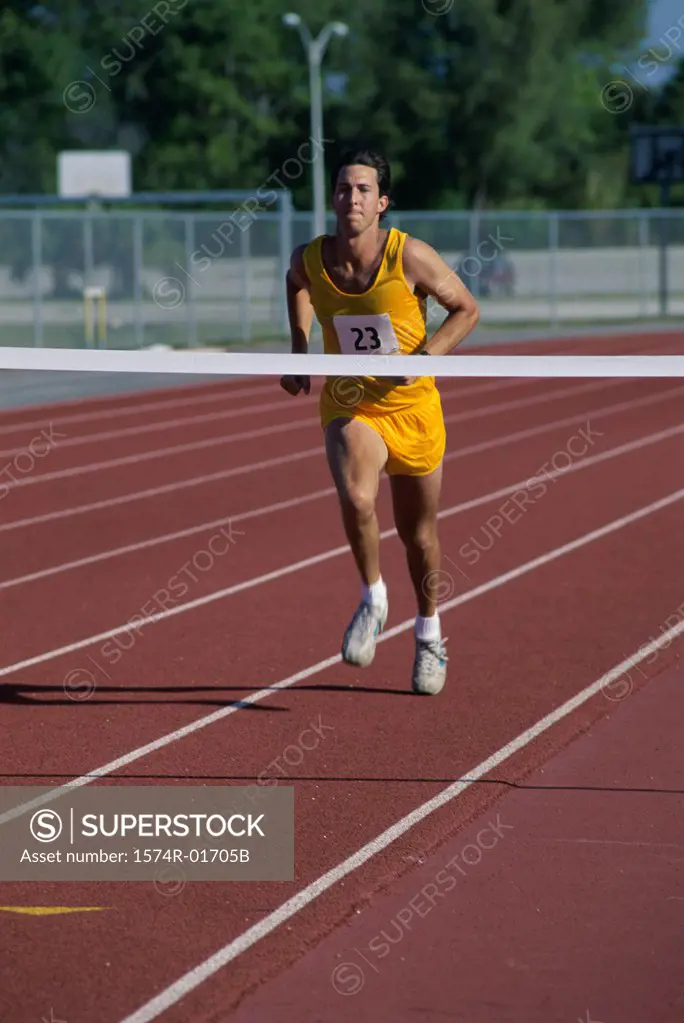 Male runner crossing a finishing line