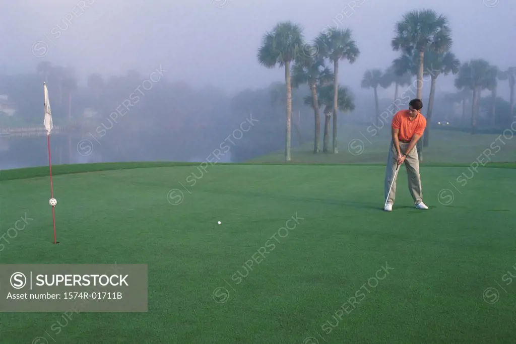 One man playing golf