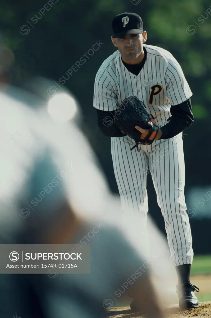Portrait of a baseball pitcher bending forward