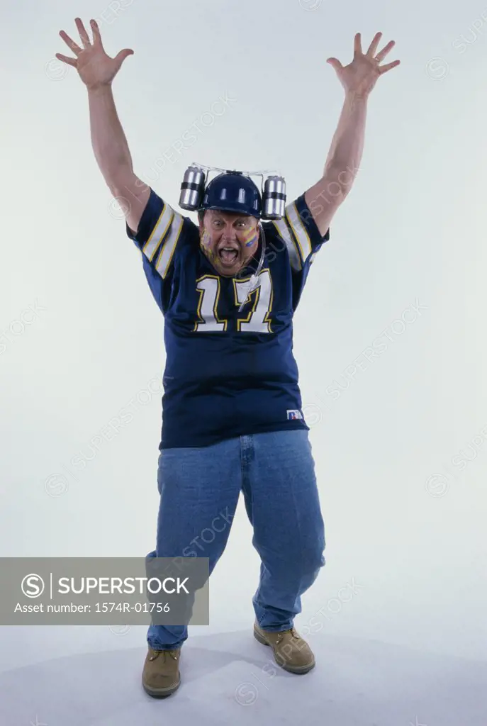 Portrait of a sports fan with his arms raised